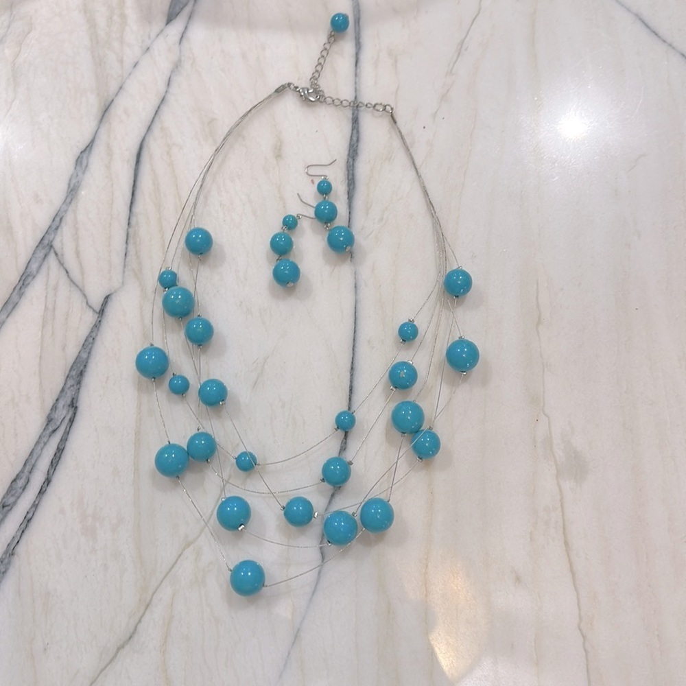 Turquoise colored bead, floating layered necklace with matching earrings